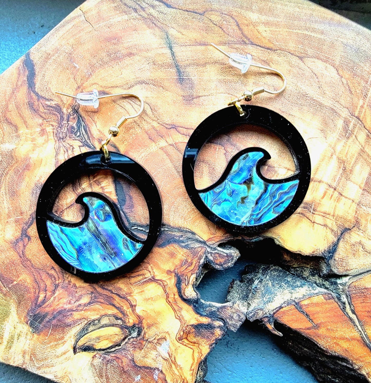 black acrylic earring with wave cut out and abalone inlay from copper canoe woman