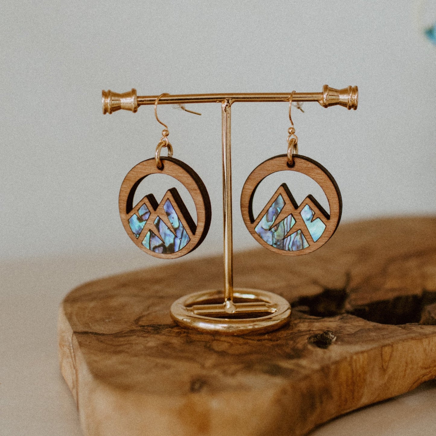 cedar earring with mountain cut out and abalone inlay from copper canoe woman