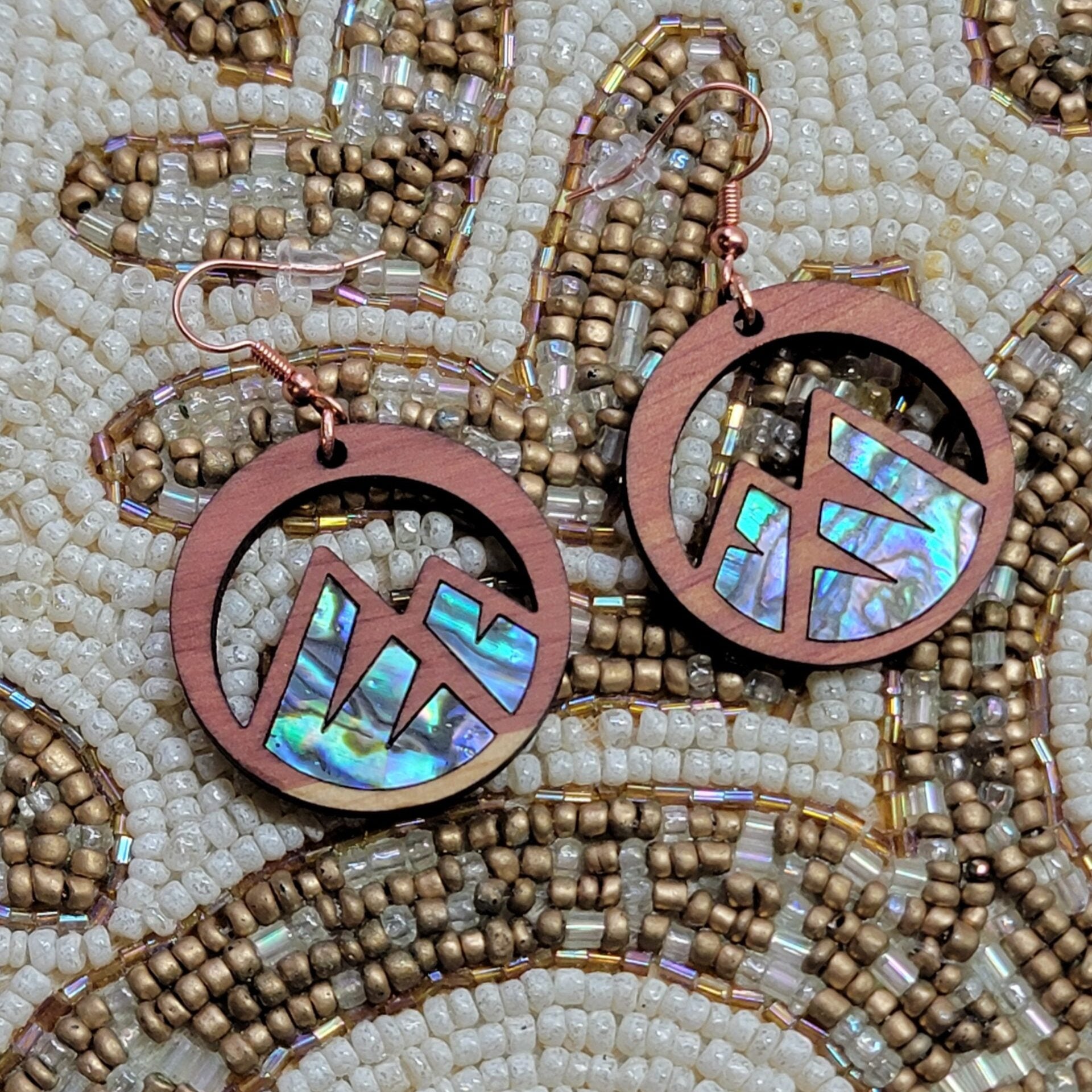 cedar earring with mountain cut out and abalone inlay from copper canoe woman