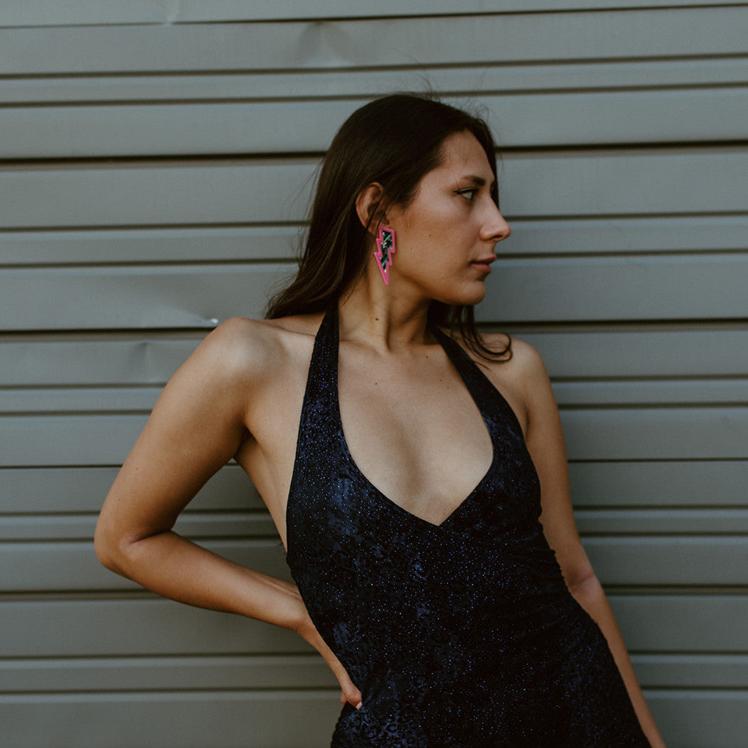 Model wearing hot pink acrylic lightning bolt earrings from Copper Canoe Woman.