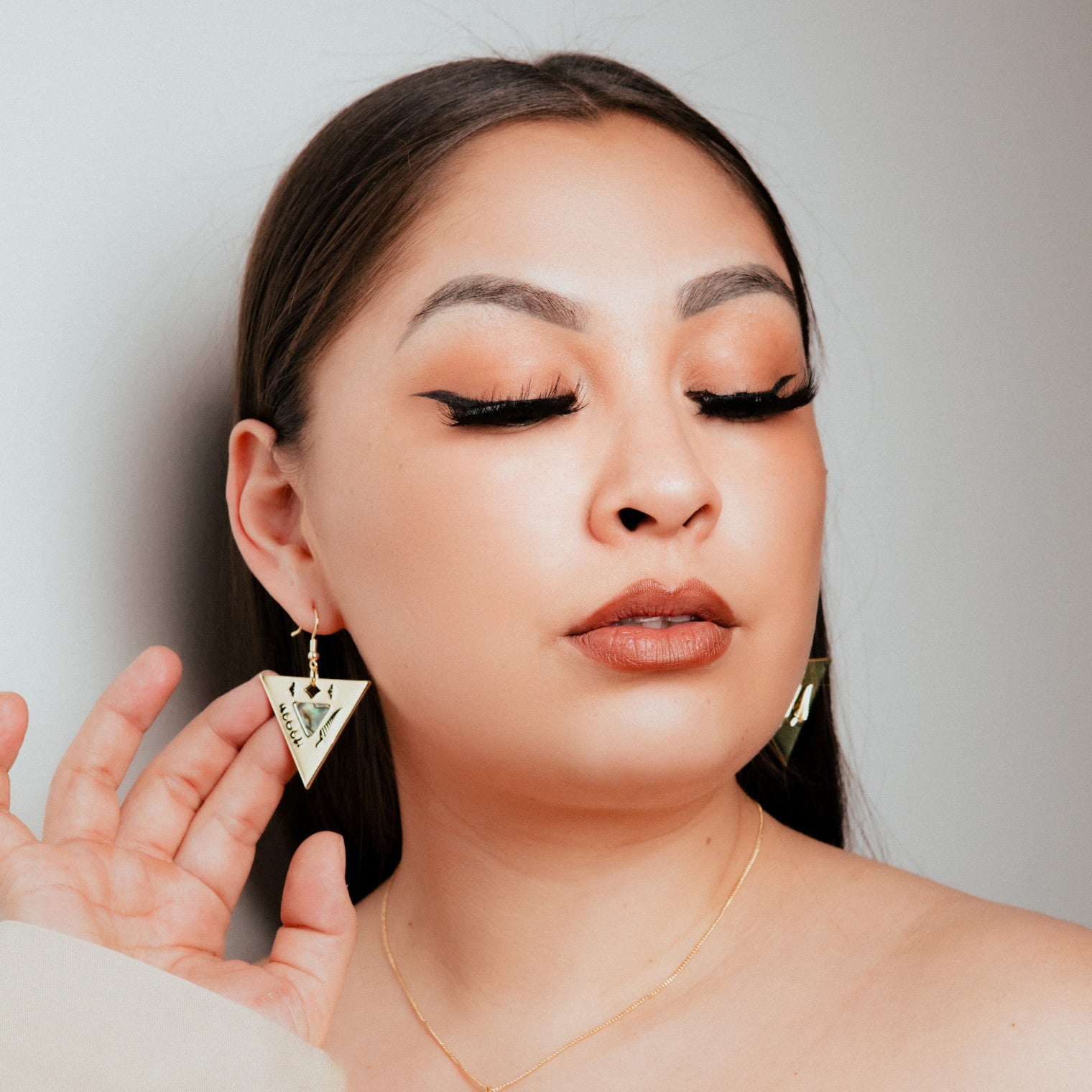 14k gold luxury indigenous triangle earring with hook.