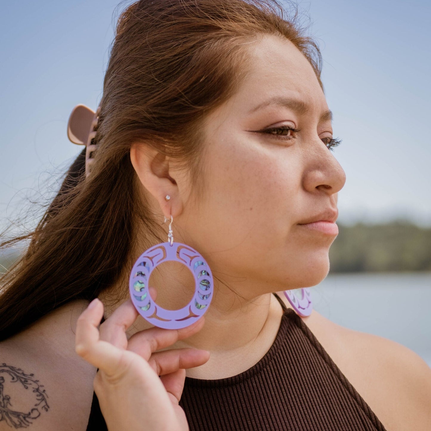 Model wearing the lavender acrylic Nala Hoop earrings from Copper Canoe Woman.