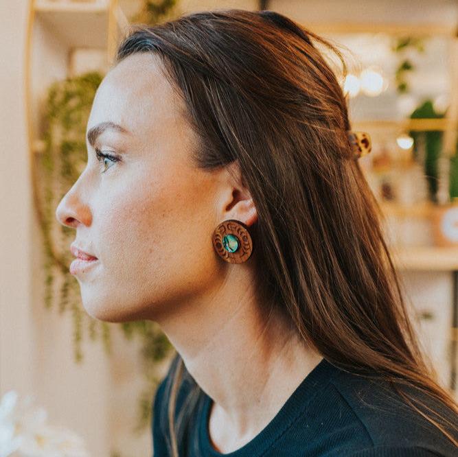 A woman wearing New Moon earrings