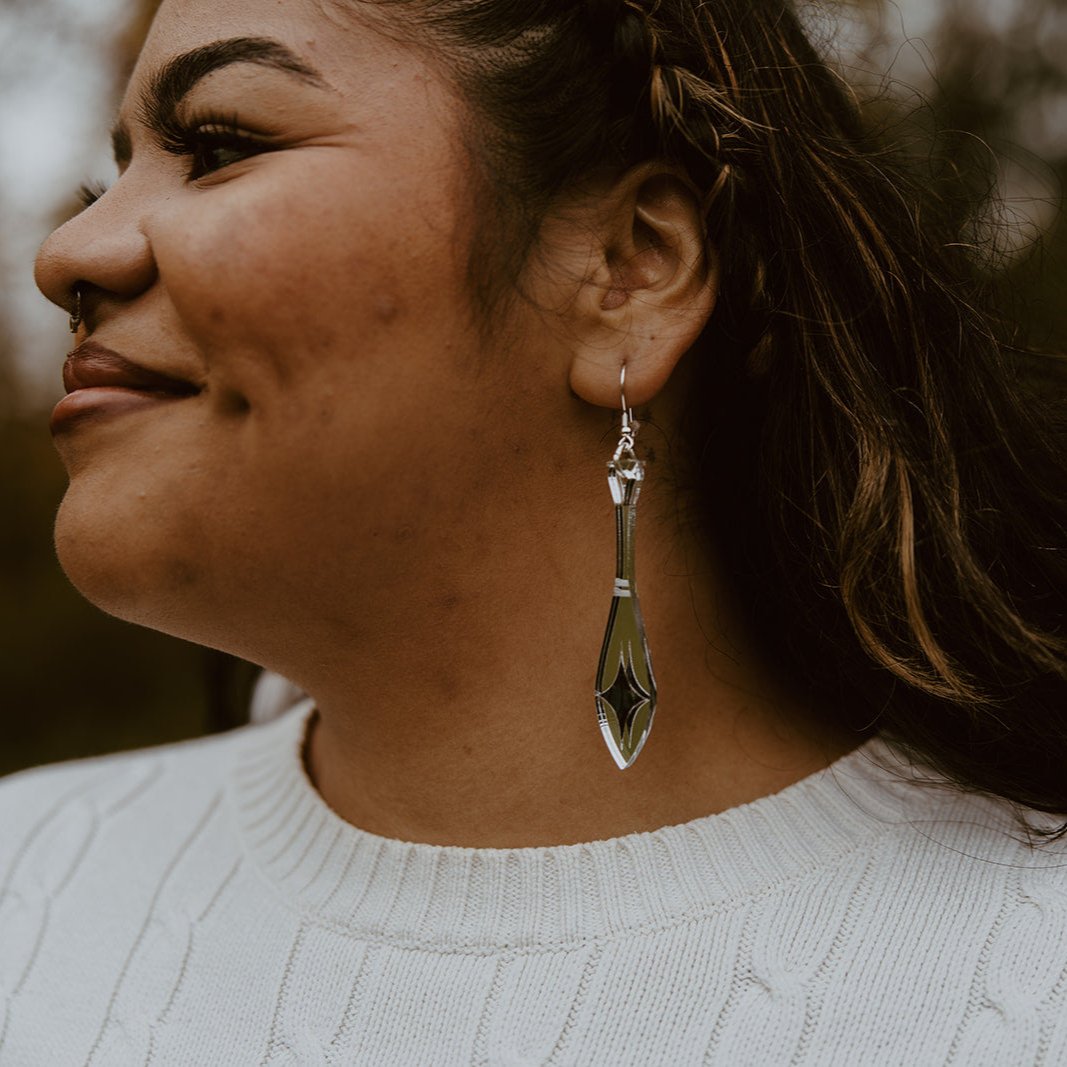 close up woman wearing silver mirror acrylic paddle earring with star abalone inlay from copper canoe woman