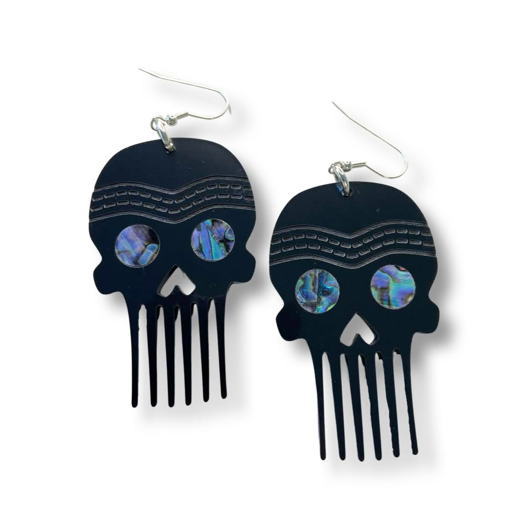 A pair of Skull Comb earrings from Copper Canoe Woman in chrome color acrylic.