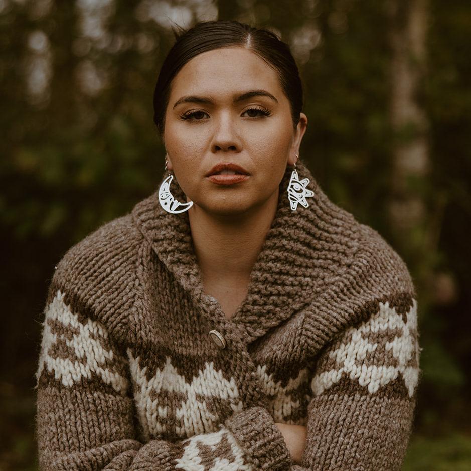 woman wearing woman wearing sterling silver sun and moon with formline art cut outs from copper canoe woman