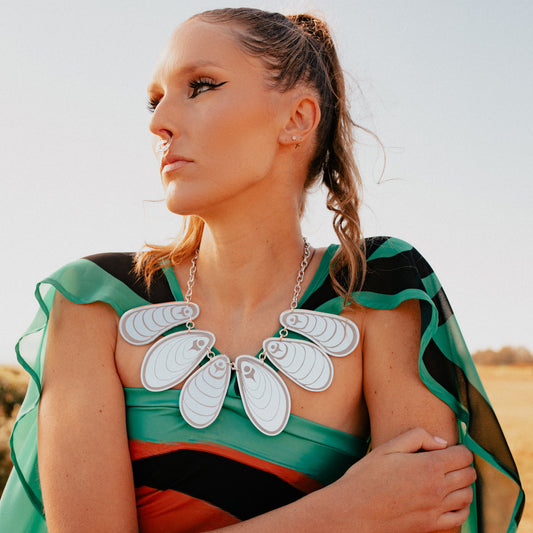 Model in profile wearing the silver mirror acrylic "Tidal Reflections" necklace by Copper Canoe Woman.