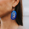 Cobalt mirror ovoid earring with abalone inlay worn by model.